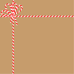 Square craft brown background with candy cane ribbon. Christmas packing string for decoration and present