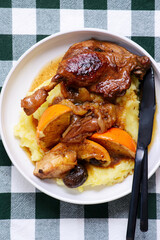 Duck legs stewed with oranges, apples and dried fruits..style rustic