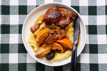 Duck legs stewed with oranges, apples and dried fruits..style rustic