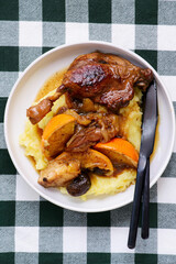 Duck legs stewed with oranges, apples and dried fruits..style rustic