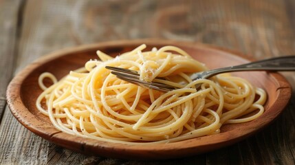 Spaghetti served without sauce on a wooden plate with a fork