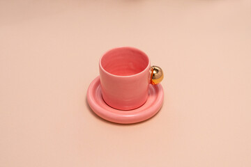 pink porcelain, with a gold handle