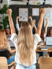 Team celebrating success with raised fists in modern office environment