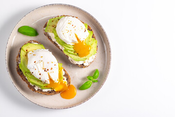 Two avocado open sandwiches with egg. Keto and diet concept. Healthy toast food for breakfast.