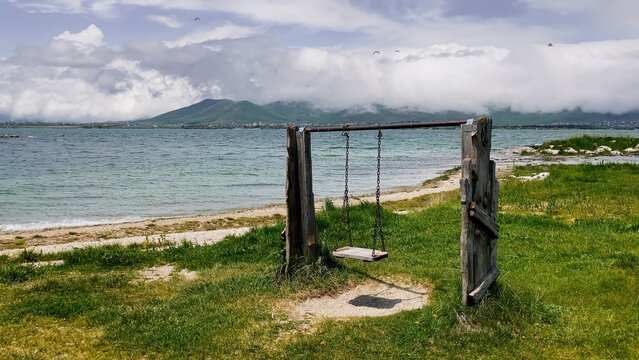 Tranquil Lakeside Swing on Beautyfull Natural View of Sevan Lake in Armenia