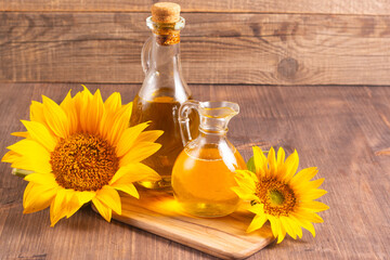 Closeup photo of sunflower oil with seeds on wooden background. Bio and organic product concept.