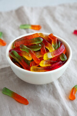 Halloween Sweet Fruit Gummy Worms in a Bowl, side view.