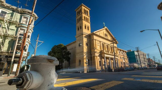 SAN-FRANCISCO , USA - OCTOBER 26, 2024: A vibrant view of a historic church with a fire hydrant in the foreground under a clear blue sky