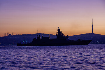 Silhouette of a military vessel entering the port of Istanbul, emphasizing the global defense of maritime trade routes to ensure their protection.
