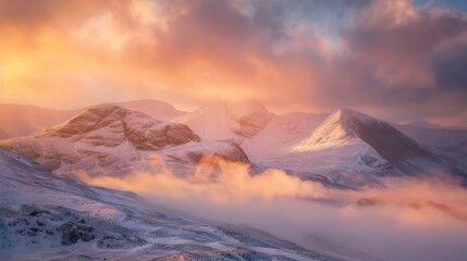 Naklejka premium Winter mountains at sunset, golden tones and misty clouds creating a serene view