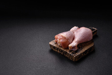 Raw chicken legs with salt, spices and herbs