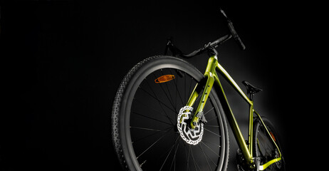 Gravel bicycle, shot from the bottom of the front wheel. Black background.