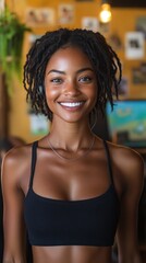 Young black woman wearing headphones smiling in a coffeeshop