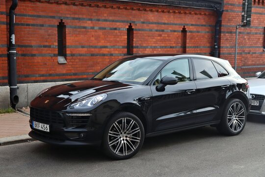 STOCKHOLM, SWEDEN - AUGUST 24, 2018: Black Porsche Macan SUV parked in Stockholm, Sweden. There are 4.8 million passenger cars registered in Sweden.