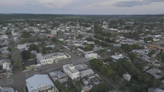 Drone descends on center of city at sunset in Oiapoque, Amap&aacute;, Brazil