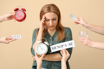 Mature woman experiencing menopause and hands with things on beige background