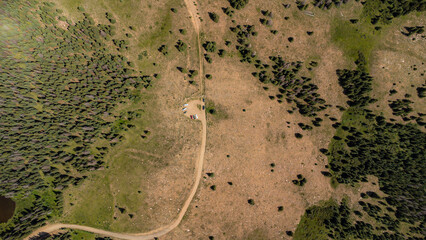 Aerial mountain view of trail through a rocky mountain forest