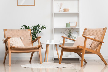 Interior of modern stylish living room with armchairs and shelving unit