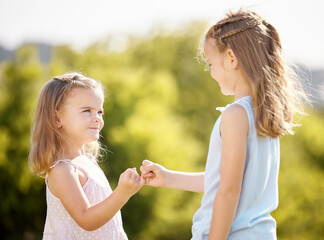 Girl, children and pinky promise in garden, happy or playful with bonding, care or secret game in...