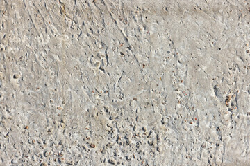 Concrete texture with small holes and irregular surface, perfect for backgrounds and design projects, construction material concept