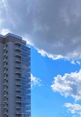 high-rise multi-storey brick house stands against a blue sky