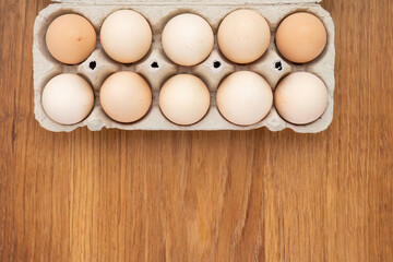 Carton of Fresh Eggs on Wooden Surface
