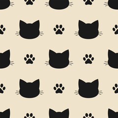 Seamless vector pattern of black cat head and paw print silhouettes on a beige background.