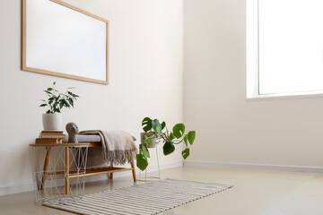Grey bench with houseplants near white wall
