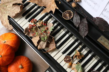 Piano keyboard and autumn decoration. Top view