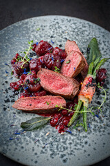Traditionally roasted fillet of saddle of venison with chestnuts, bacon-wrapped bean sticks and...