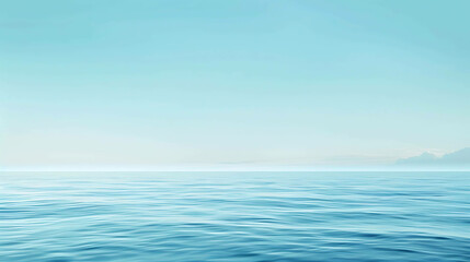 Obraz premium This is a beautiful image of a calm sea. The water is a deep blue color and the sky is a light blue color.