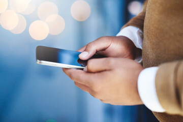 Business, hands and phone with typing in office for text message, checking notifications or writing email. Professional, person and smartphone on bokeh for internet browsing, research or mobile chat