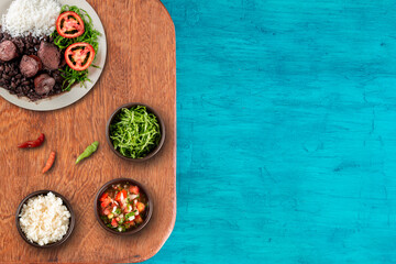 Traditional Brazilian feijoada with a blue background