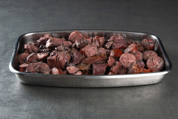 Traditional Brazilian feijoada. Tray with meat and sausage ingredients