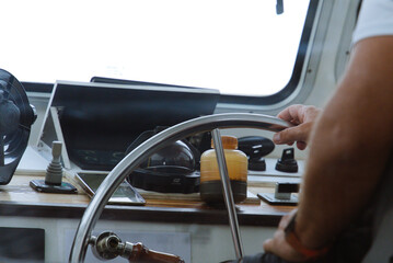 Skipper at the Helm: Steering the Boat from the Interior © GBSPhotography