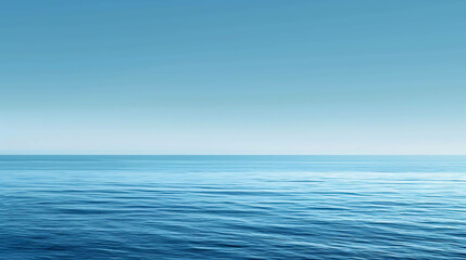 Obraz premium Deep blue ocean with a clear blue sky. The water is calm and still, with small waves rippling on the surface.