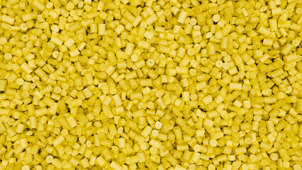 Closeup top view of yellow plastic polypropylene granules, masterbatch polymer grain. HDPE or PVC resin pellets. 3d render illustration