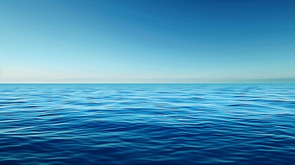 Obraz premium Deep blue ocean with a clear blue sky. The water is calm and serene, with gentle waves rippling across the surface.