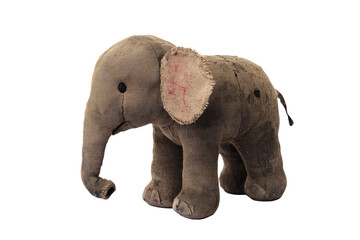 Obraz premium An antique stuffed elephant features tattered fabric with faded colors, exuding a historic charm and nostalgic essence, set in a classic pose to capture enduring appeal.