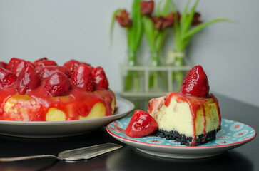Baked strawberry cheesecake with fresh strawberries from the garden and dripping coulis, slice of cake
