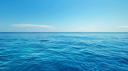 Fototapeta premium The deep blue sea stretches out before you, endless and inviting. The sky is clear and blue, with just a few clouds dotting the horizon.