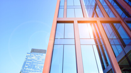Modern stylish architecture. Symmetrical blue glass building in the city. Cityscape office buildings with modern corporate architecture - business and success concept.