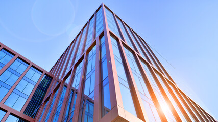 Modern stylish architecture. Symmetrical blue glass building in the city. Cityscape office...