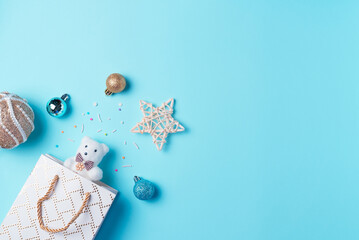 Christmas background with toy and balls on blue background from above. Flat lay, top view. Copy space