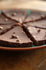 Fluffy chocolate cake with chocolate pieces on top, vertical, close-up