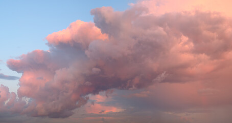 A beautiful blue sky with a few clouds and a pinkish hue. The sky is clear and the clouds are scattered throughout the sky