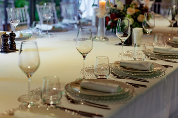 Beautiful table setting, for a holiday. with the dishes .flowers and candles