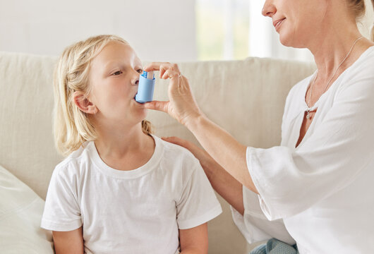 Mother, girl and inhaler for symptoms, breathing and illness in living room for relief or care in house. Woman, child and sick in home with asthma pump, prescription and wellness as medical condition