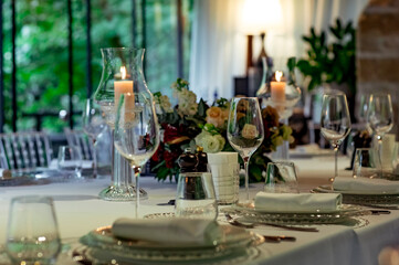 Beautiful table setting, for a holiday. with the dishes .flowers and candles