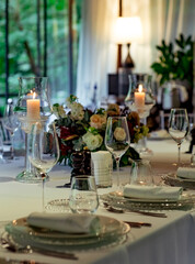 Beautiful table setting, for a holiday. with the dishes .flowers and candles